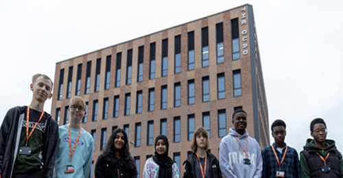 A photograph of students outside the new Quad building